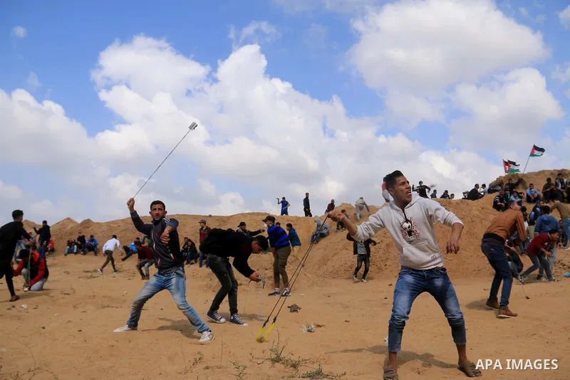 Palestinian protesters clash with Israeli security forces in a tent city protest at along the Israel border with Gaza, demanding the right to return to their homeland, in al-Bureij in the center of Gaza strip on March 30...
