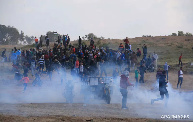 Palestinian protesters clash with Israeli security forces in a tent city protest at along the Israel border with Gaza, demanding the right to return to their homeland, in al-Bureij in the center of Gaza strip on March 30...