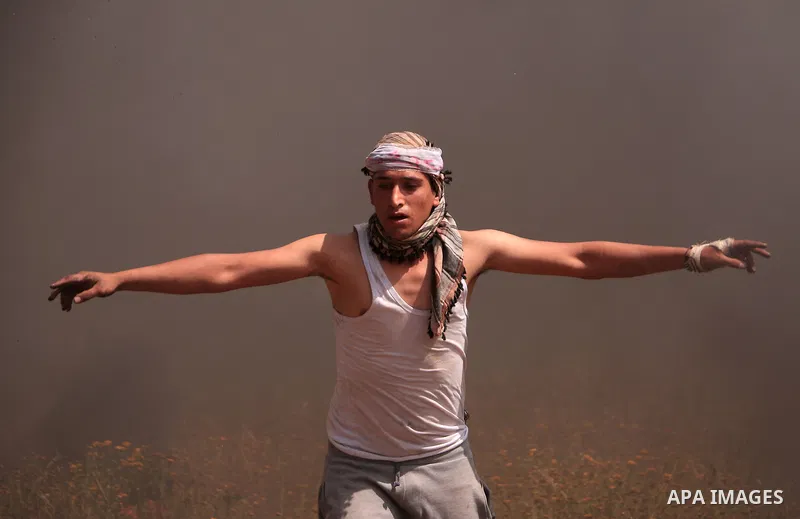 A Palestinian protester takes part during a tent city protest along the Israel border with Gaza, demanding the right to return to their homeland, in Khan Younis in the southern Gaza Strip March 30, 2018. Photo by Sanad L...