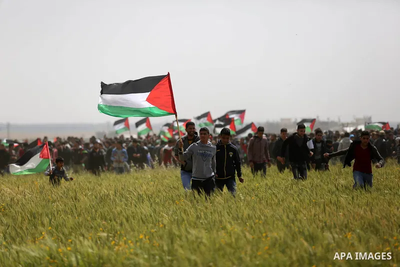 Palestinian protesters take part during a tent city protest along the Israel border with Gaza, demanding the right to return to their homeland, in Khan Younis in the southern Gaza Strip March 30, 2018. Photo by Ashraf Am...