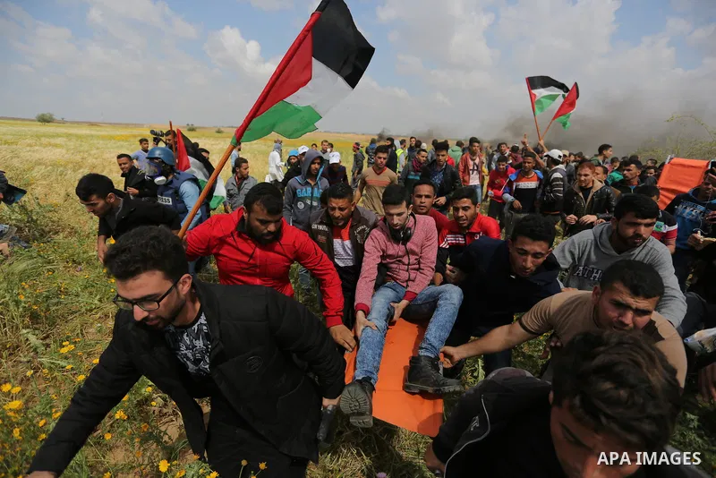 A wounded Palestinian is evacuated during clashes with Israeli security forces during a tent city protest along the Israel border with Gaza, demanding the right to return to their homeland, in Khan Younis in the southern...