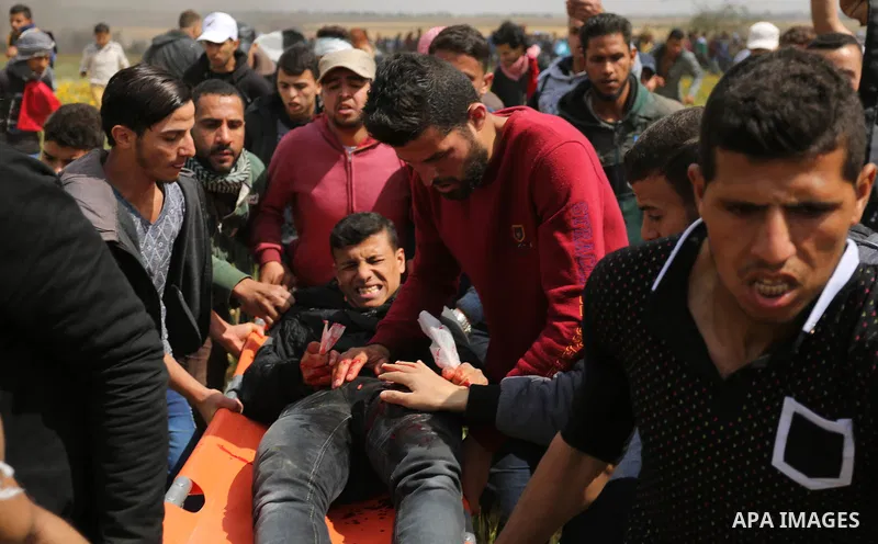 A wounded Palestinian is evacuated during clashes with Israeli security forces during a tent city protest along the Israel border with Gaza, demanding the right to return to their homeland, in Khan Younis in the southern...