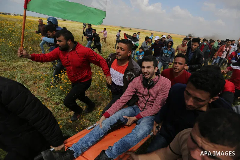 A wounded Palestinian is evacuated during clashes with Israeli security forces during a tent city protest along the Israel border with Gaza, demanding the right to return to their homeland, in Khan Younis in the southern...