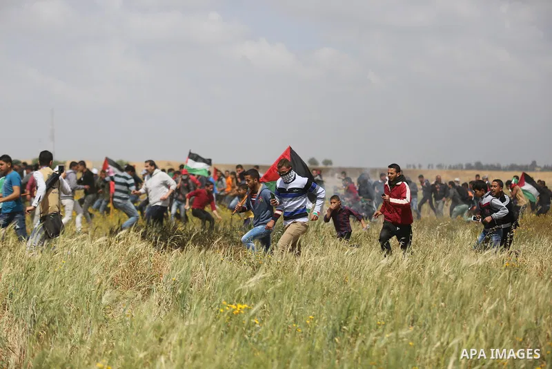 Palestinian protesters take part during a tent city protest along the Israel border with Gaza, demanding the right to return to their homeland, in Khan Younis in the southern Gaza Strip March 30, 2018. Photo by Ashraf Am...