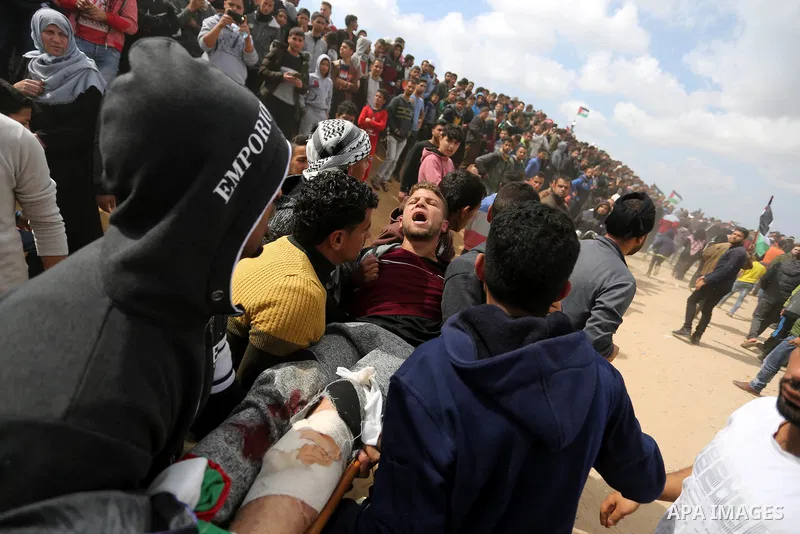 A wounded Palestinian is evacuated during clashes with Israeli security forces during a tent city protest along the Israel border with Gaza, demanding the right to return to their homeland, in Khan Younis in the southern...