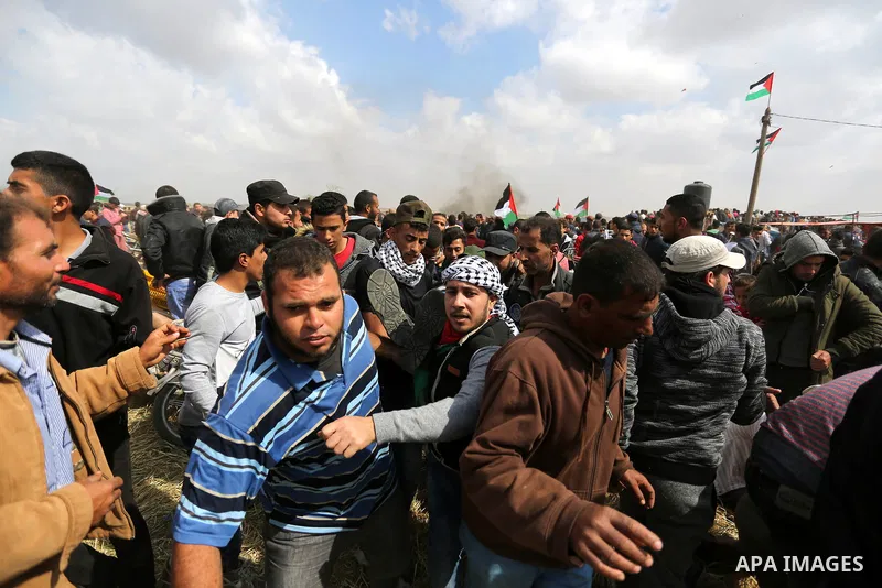 A wounded Palestinian is evacuated during clashes with Israeli security forces during a tent city protest along the Israel border with Gaza, demanding the right to return to their homeland, in Khan Younis in the southern...