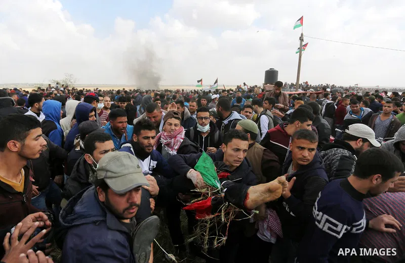A wounded Palestinian is evacuated during clashes with Israeli security forces during a tent city protest along the Israel border with Gaza, demanding the right to return to their homeland, in Khan Younis in the southern...