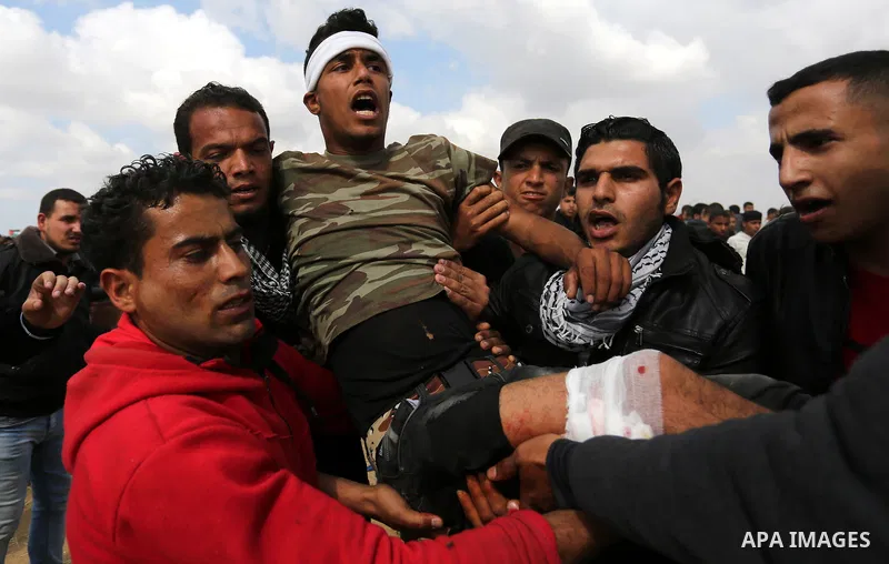 A wounded Palestinian is evacuated during clashes with Israeli security forces during a tent city protest along the Israel border with Gaza, demanding the right to return to their homeland, in Khan Younis in the southern...