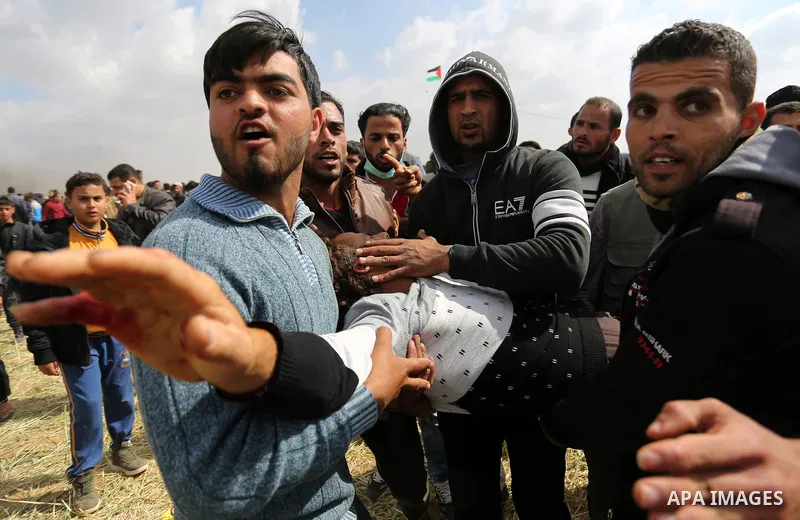 A wounded Palestinian is evacuated during clashes with Israeli security forces during a tent city protest along the Israel border with Gaza, demanding the right to return to their homeland, in Khan Younis in the southern...