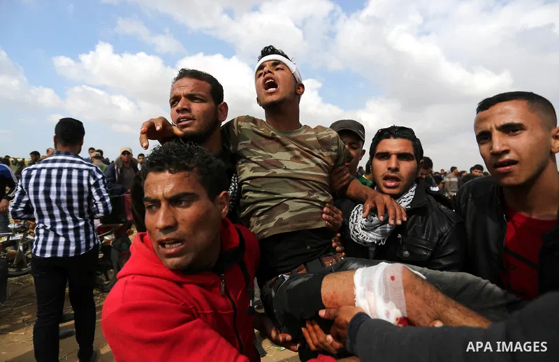 A wounded Palestinian is evacuated during clashes with Israeli security forces during a tent city protest along the Israel border with Gaza, demanding the right to return to their homeland, in Khan Younis in the southern...