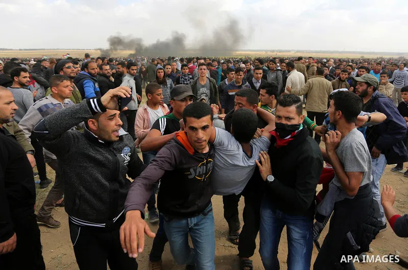 A wounded Palestinian is evacuated during clashes with Israeli security forces during a tent city protest along the Israel border with Gaza, demanding the right to return to their homeland, in Khan Younis in the southern...