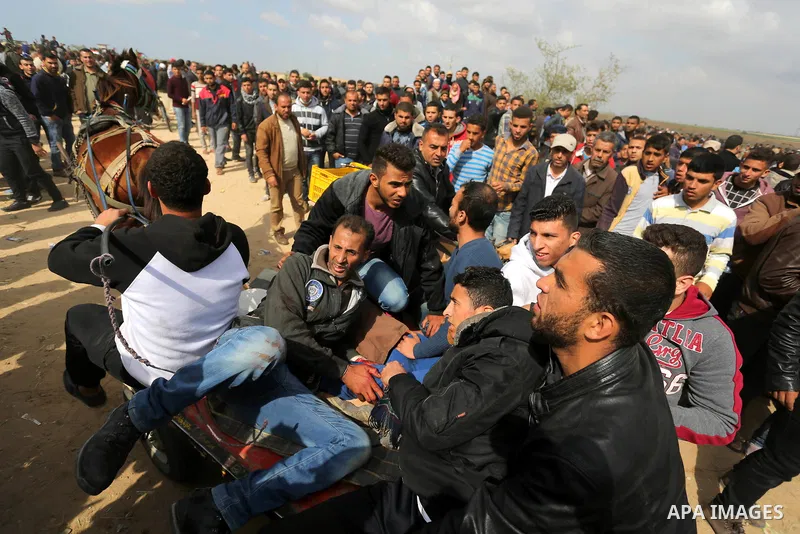 A wounded Palestinian is evacuated during clashes with Israeli security forces during a tent city protest along the Israel border with Gaza, demanding the right to return to their homeland, in Khan Younis in the southern...