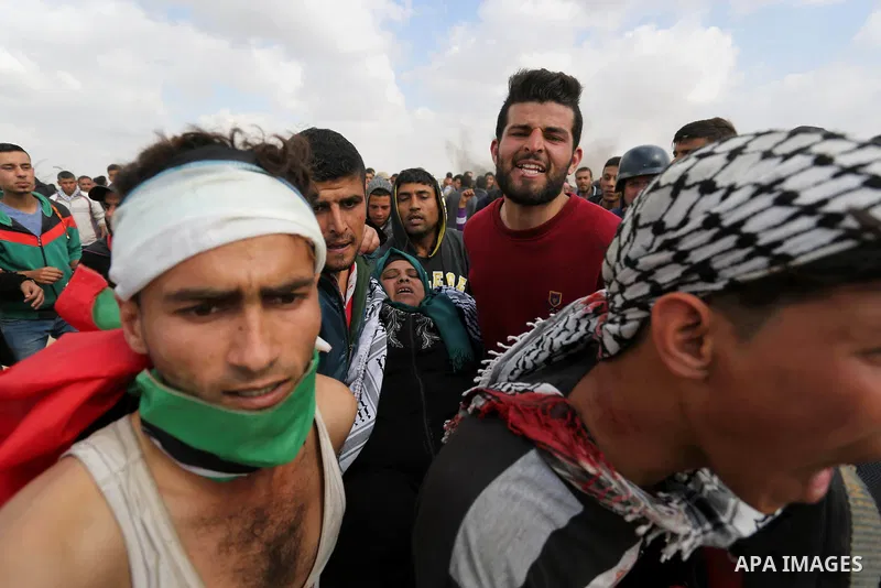 A wounded Palestinian woman is evacuated during clashes with Israeli security forces during a tent city protest along the Israel border with Gaza, demanding the right to return to their homeland, in Khan Younis in the so...