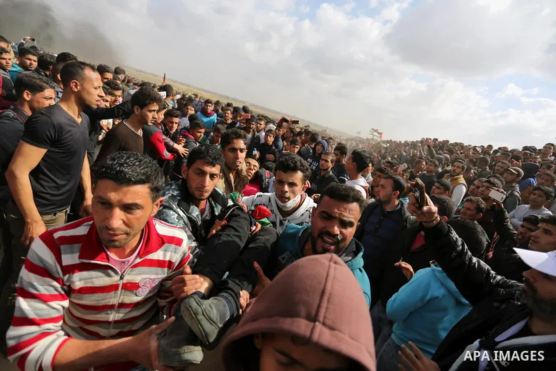 A wounded Palestinian is evacuated during clashes with Israeli security forces during a tent city protest along the Israel border with Gaza, demanding the right to return to their homeland, in Khan Younis in the southern...