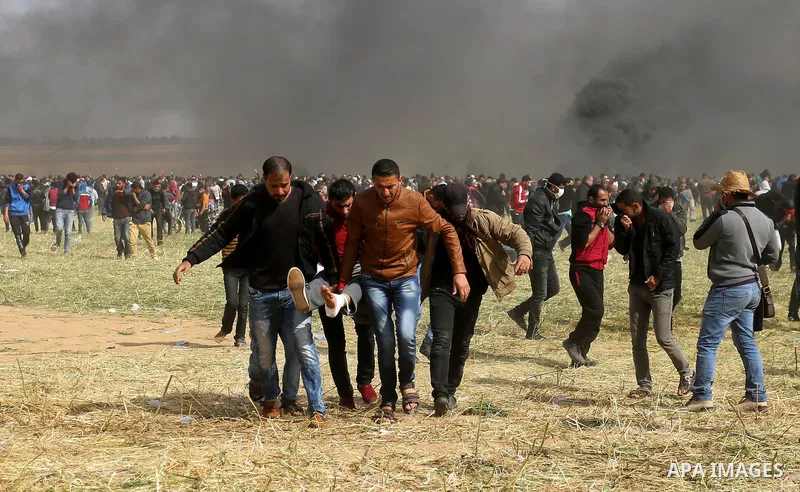 A wounded Palestinian is evacuated during clashes with Israeli security forces during a tent city protest along the Israel border with Gaza, demanding the right to return to their homeland, in Khan Younis in the southern...