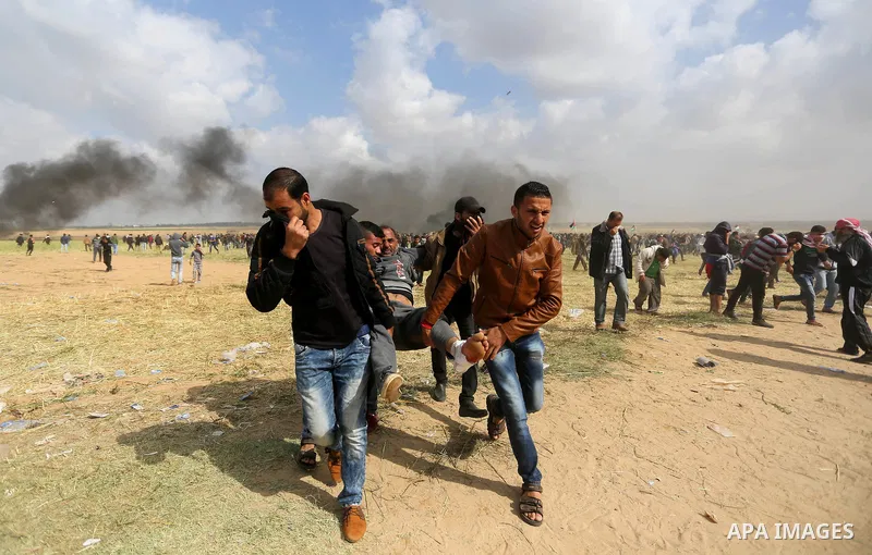 A wounded Palestinian is evacuated during clashes with Israeli security forces during a tent city protest along the Israel border with Gaza, demanding the right to return to their homeland, in Khan Younis in the southern...