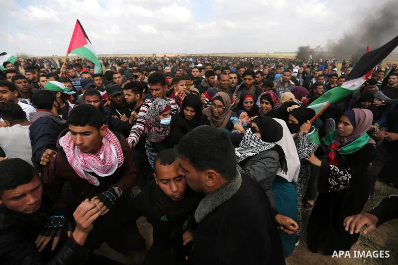 A wounded Palestinian woman is evacuated during clashes with Israeli security forces during a tent city protest along the Israel border with Gaza, demanding the right to return to their homeland, in Khan Younis in the so...
