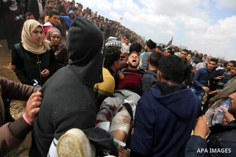 A wounded Palestinian is evacuated during clashes with Israeli security forces during a tent city protest along the Israel border with Gaza, demanding the right to return to their homeland, in Khan Younis in the southern...
