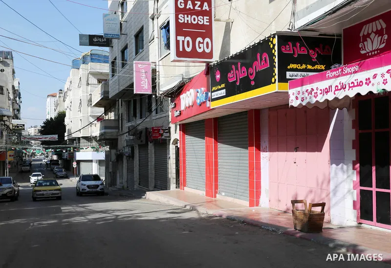 Palestinians walk past closed shops in Gaza City during a general strike, to mourn for the 15 Palestinians who was killed during clashes with Israeli security forces in a tent city protest along the Israel borders with G...