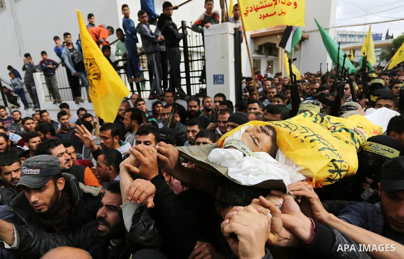 Palestinians carry the body of Hamdan Abu Amsha who was killed a day earlier during clashes with Israeli security forces in a tent city protest along the Israel border with Gaza, demanding the right to return to their ho...
