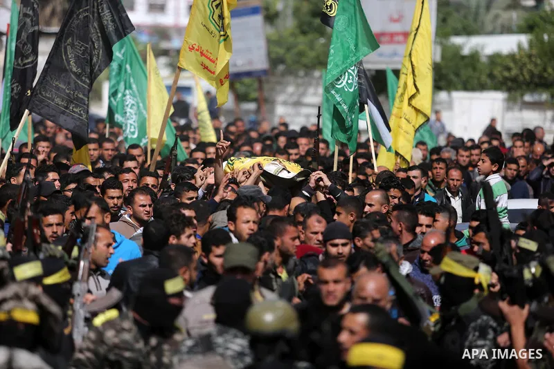 Palestinians carry the body of Hamdan Abu Amsha who was killed a day earlier during clashes with Israeli security forces in a tent city protest along the Israel border with Gaza, demanding the right to return to their ho...