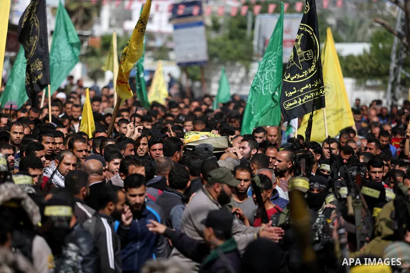 Palestinians carry the body of Hamdan Abu Amsha who was killed a day earlier during clashes with Israeli security forces in a tent city protest along the Israel border with Gaza, demanding the right to return to their ho...