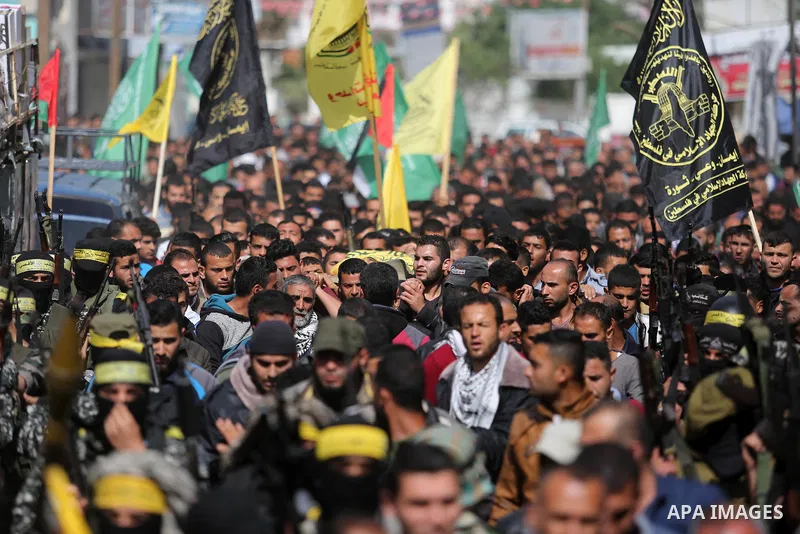 Palestinians carry the body of Hamdan Abu Amsha who was killed a day earlier during clashes with Israeli security forces in a tent city protest along the Israel border with Gaza, demanding the right to return to their ho...