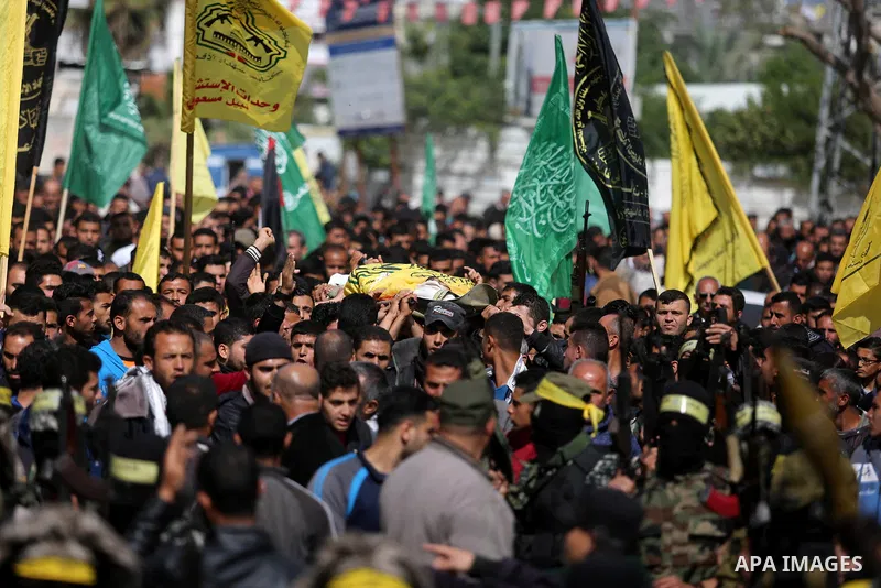 Palestinians carry the body of Hamdan Abu Amsha who was killed a day earlier during clashes with Israeli security forces in a tent city protest along the Israel border with Gaza, demanding the right to return to their ho...