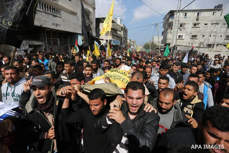 Palestinians carry the body of Hamdan Abu Amsha who was killed a day earlier during clashes with Israeli security forces in a tent city protest along the Israel border with Gaza, demanding the right to return to their ho...