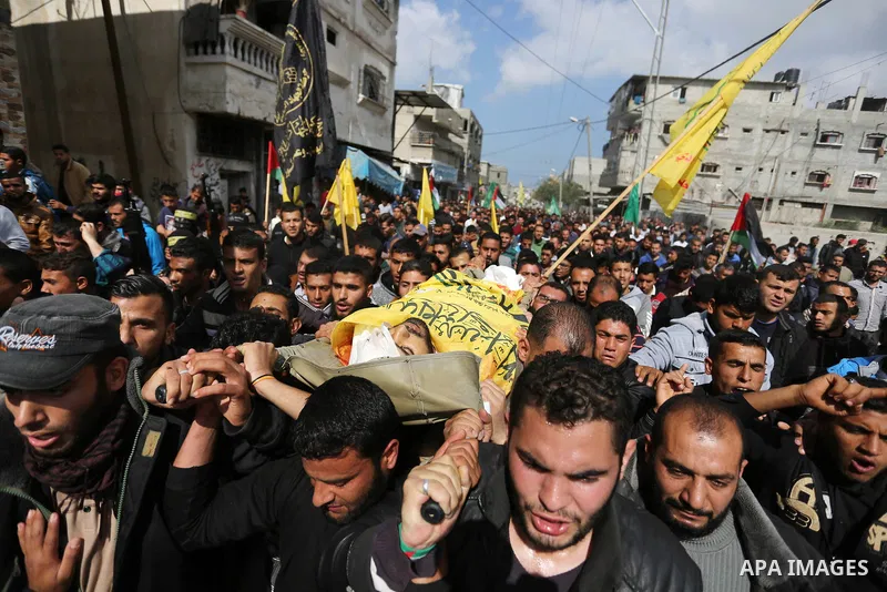 Palestinians carry the body of Hamdan Abu Amsha who was killed a day earlier during clashes with Israeli security forces in a tent city protest along the Israel border with Gaza, demanding the right to return to their ho...