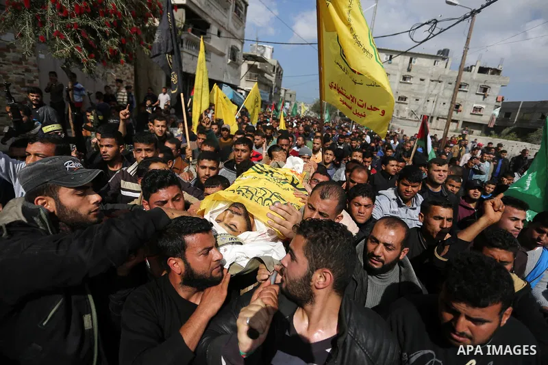 Palestinians carry the body of Hamdan Abu Amsha who was killed a day earlier during clashes with Israeli security forces in a tent city protest along the Israel border with Gaza, demanding the right to return to their ho...