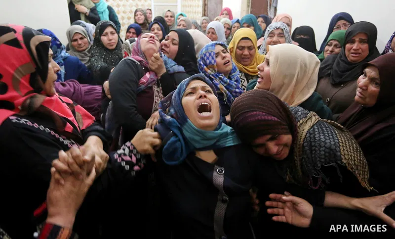 Relatives of Palestinian Hamdan Abu Amshah who was killed a day earlier during clashes with Israeli security forces in a tent city protest along the Israel border with Gaza, demanding the right to return to their homelan...
