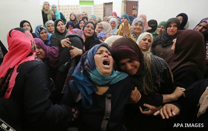 Relatives of Palestinian Hamdan Abu Amshah who was killed a day earlier during clashes with Israeli security forces in a tent city protest along the Israel border with Gaza, demanding the right to return to their homelan...
