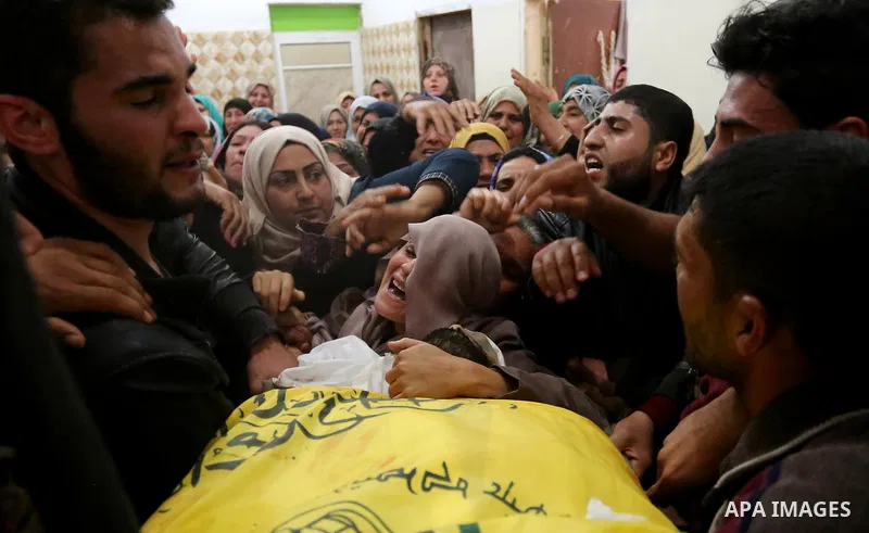 Relatives of Palestinian Hamdan Abu Amshah who was killed a day earlier during clashes with Israeli security forces in a tent city protest along the Israel border with Gaza, demanding the right to return to their homelan...
