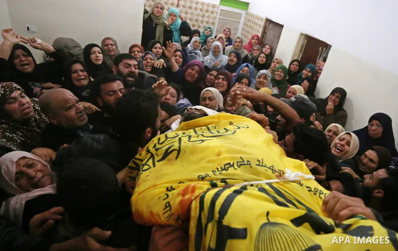Relatives of Palestinian Hamdan Abu Amshah who was killed a day earlier during clashes with Israeli security forces in a tent city protest along the Israel border with Gaza, demanding the right to return to their homelan...