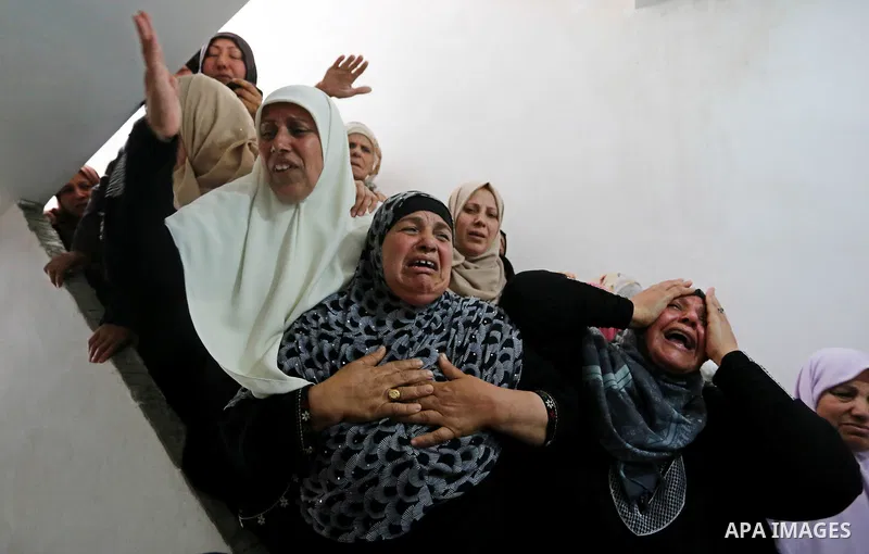 Relatives of Palestinian Hamdan Abu Amshah who was killed a day earlier during clashes with Israeli security forces in a tent city protest along the Israel border with Gaza, demanding the right to return to their homelan...