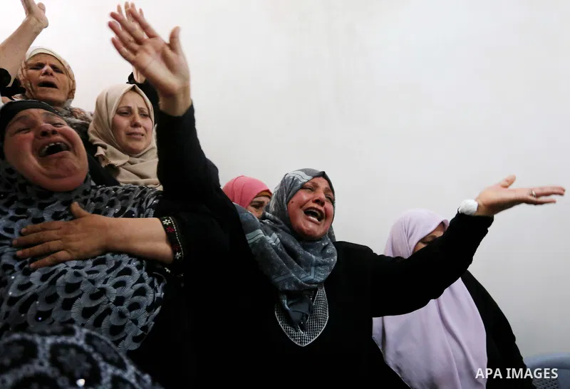 Relatives of Palestinian Hamdan Abu Amshah who was killed a day earlier during clashes with Israeli security forces in a tent city protest along the Israel border with Gaza, demanding the right to return to their homelan...