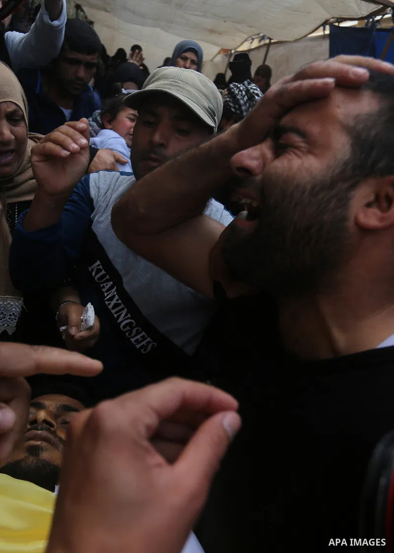 Palestinians carry the body of Jihad Abu Jamous who was killed a day earlier during clashes with Israeli security forces in a tent city protest along the Israel border with Gaza, demanding the right to return to their ho...