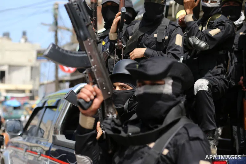 Palestinian militants of Al-Aqsa Martyrs' Brigades attend a funeral of Jihad Abu Jamous who was killed a day earlier during clashes with Israeli security forces in a tent city protest along the Israel border with Gaza, d...