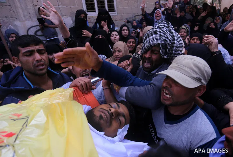 Palestinians carry the body of Jihad Abu Jamous who was killed a day earlier during clashes with Israeli security forces in a tent city protest along the Israel border with Gaza, demanding the right to return to their ho...