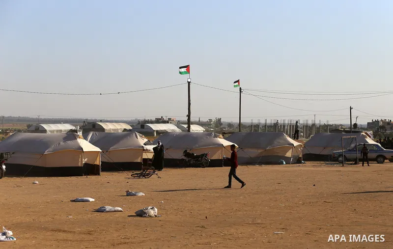 Palestinians take part during a tent city protest along the border with Israel, east of Khan Yunis, in the southern Gaza Strip on March 31, 2018. The UN Security Council heard fears of a further escalation in Israeli-Pal...