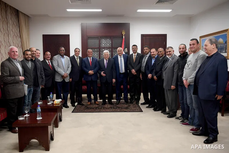 Palestinian President Mahmoud Abbas, meets with a delegation from the Department of Youth and Sports at the Arab University, in the West Bank city of Ramallah, on March 31, 2018. Photo by Osama Falah