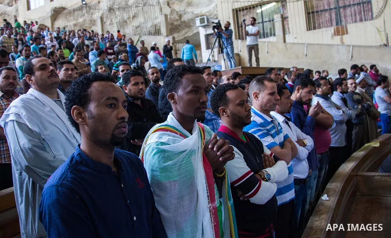Egyptian Orthodox Christians take part in a mass marking the Palm Sunday at a church in Saint Samaan the tanner Monastery in Cairo on April 1, 2018. Photo by Stringer