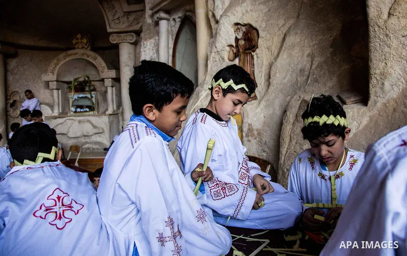 Egyptian Orthodox Christians take part in a mass marking the Palm Sunday at a church in Saint Samaan the tanner Monastery in Cairo on April 1, 2018. Photo by Stringer