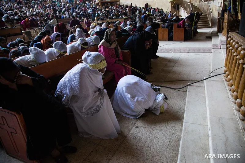 Egyptian Orthodox Christians take part in a mass marking the Palm Sunday at a church in Saint Samaan the tanner Monastery in Cairo on April 1, 2018. Photo by Stringer