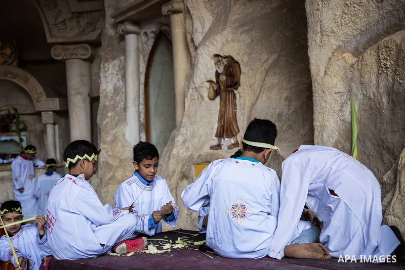Egyptian Orthodox Christians take part in a mass marking the Palm Sunday at a church in Saint Samaan the tanner Monastery in Cairo on April 1, 2018. Photo by Stringer
