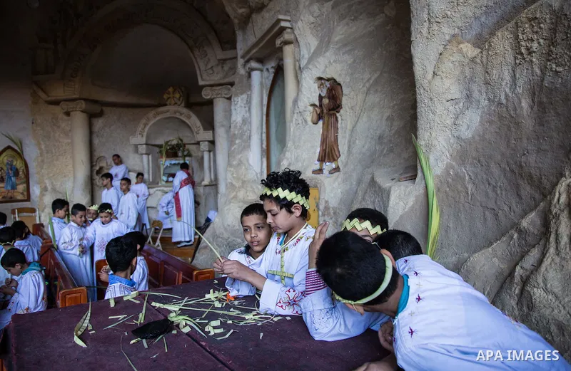 Egyptian Orthodox Christians take part in a mass marking the Palm Sunday at a church in Saint Samaan the tanner Monastery in Cairo on April 1, 2018. Photo by Stringer