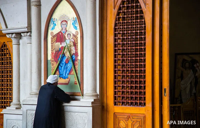 Egyptian Orthodox Christians take part in a mass marking the Palm Sunday at a church in Saint Samaan the tanner Monastery in Cairo on April 1, 2018. Photo by Stringer