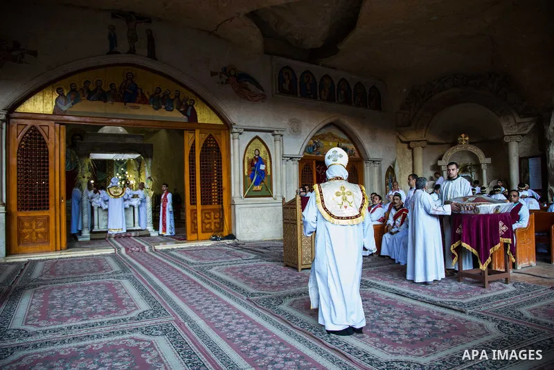 Egyptian Orthodox Christians take part in a mass marking the Palm Sunday at a church in Saint Samaan the tanner Monastery in Cairo on April 1, 2018. Photo by Stringer