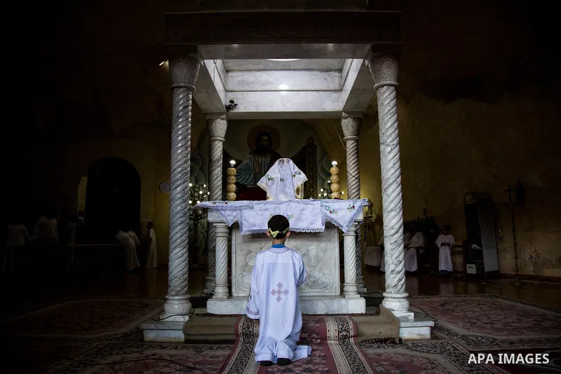 Egyptian Orthodox Christians take part in a mass marking the Palm Sunday at a church in Saint Samaan the tanner Monastery in Cairo on April 1, 2018. Photo by Stringer